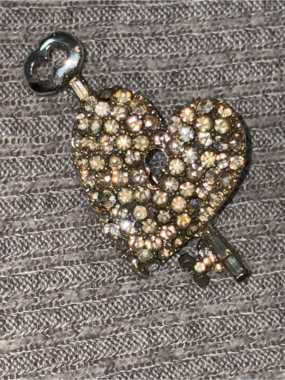 Vintage silver tone rhinestone studded heart brooch w key across it